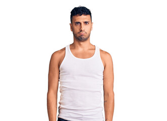 Fototapeta premium Young hispanic man wearing casual clothes depressed and worry for distress, crying angry and afraid. sad expression.