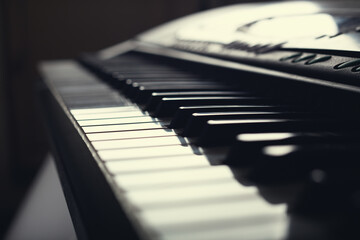 Closeup of piano keys on a synthesizer. Close-up of musical instrument piano keys.