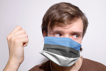 Young Estonian man wearing Estonia face mask during coronavirus pandemic