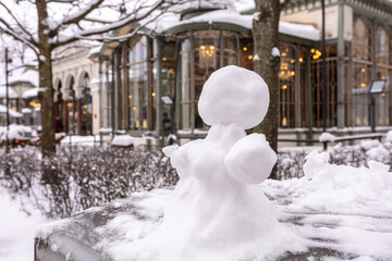 Snowman, snow woman molded from snow. Snowy winter concept. - obrazy, fototapety, plakaty
