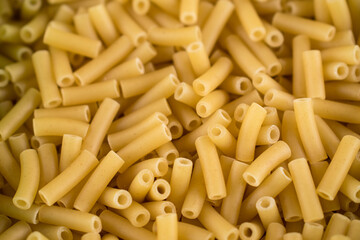 Close up of some raw macaroni in a green pot 
