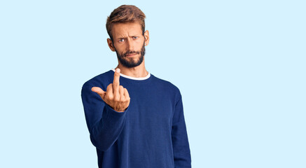 Handsome blond man with beard wearing casual sweater showing middle finger, impolite and rude fuck...