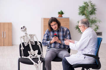 Young male patient visiting experienced doctor psychiatrist