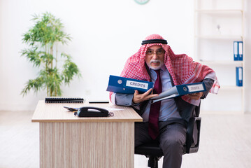 Male arab bookkeeper extremely tired with an excessive work