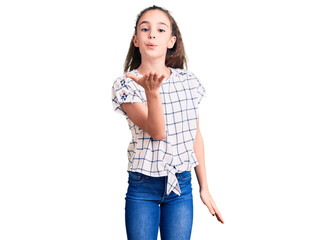 Fototapeta premium Cute hispanic child girl wearing casual clothes looking at the camera blowing a kiss with hand on air being lovely and sexy. love expression.