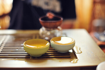 Close-up of a tea ceremony indoors.
