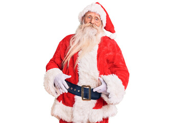 Old senior man with grey hair and long beard wearing traditional santa claus costume looking sleepy and tired, exhausted for fatigue and hangover, lazy eyes in the morning.