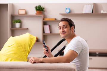 Young male contractor looking after new born at home