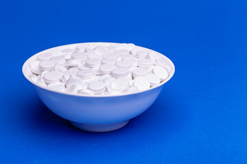 plate with tablets on a blue background.