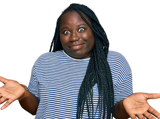 Young black woman with braids wearing casual clothes clueless and confused expression with arms and...