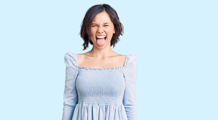 Young beautiful girl wearing casual clothes sticking tongue out happy with funny expression. emotion concept. © Krakenimages.com