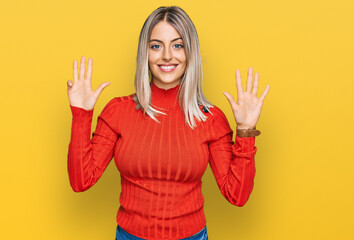 Beautiful blonde woman wearing casual clothes showing and pointing up with fingers number nine...