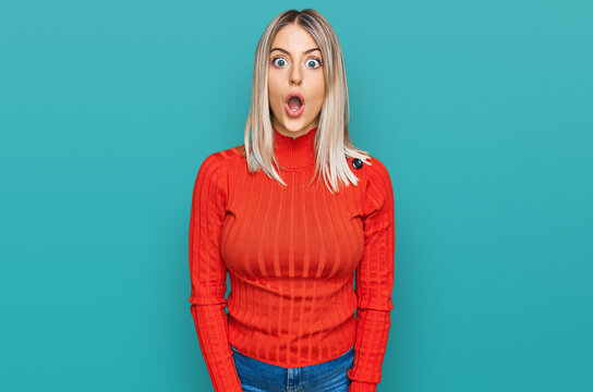 Beautiful blonde woman wearing casual clothes afraid and shocked with surprise and amazed expression, fear and excited face.
