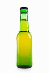 Close-up of glass green bottle of beer on a white background. The bottle is closed.