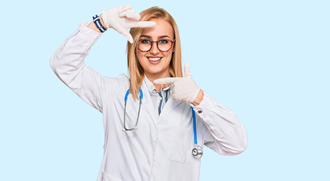 Beautiful caucasian woman wearing doctor uniform and stethoscope smiling making frame with hands and fingers with happy face. creativity and photography concept.