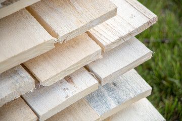 Wooden planks stacked. Rough lumber construction material