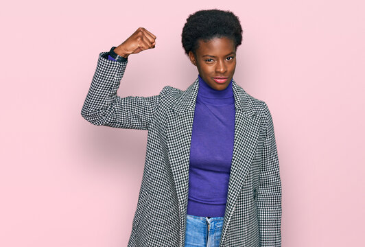 Young african american girl wearing casual clothes strong person showing arm muscle, confident and proud of power