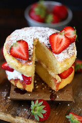 Soft focus. Victoria sponge cake. The famous dessert biscuit with strawberries.