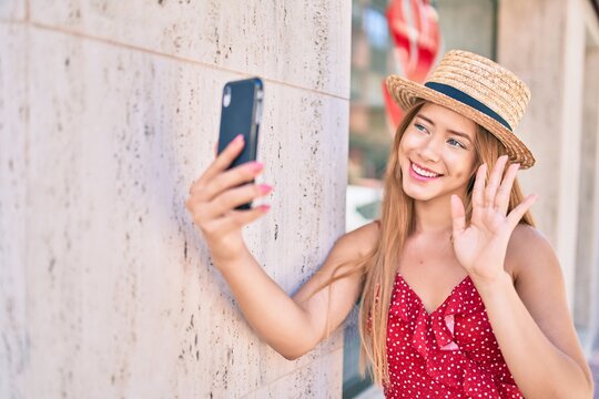 Young caucasian tourist girl smiling happy doing video call using smartphone at the city.
