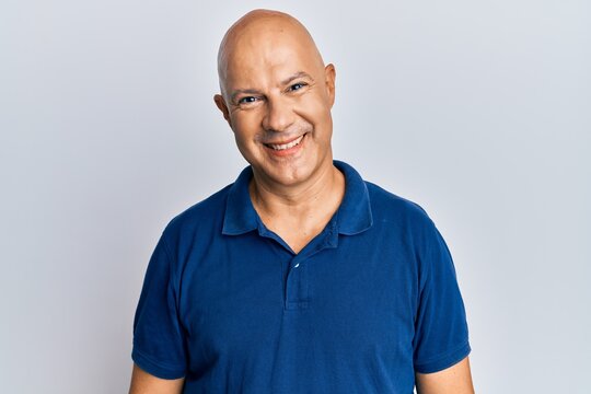 Middle age bald man wearing casual clothes with a happy and cool smile on face. lucky person.