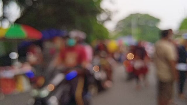 blurred outfocused defocused bokeh view of Sunday morning activty of people in Surabaya Indonesia around National Great Mosque with people gathering, jogging, sightseeing and shopping at local tempora