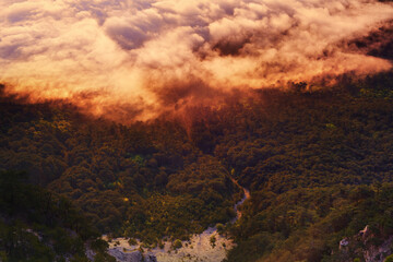Fototapeta na wymiar Panoramic view of the clouds in the mountains at sunrise.