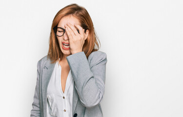 Young caucasian woman wearing business style and glasses yawning tired covering half face, eye and mouth with hand. face hurts in pain.