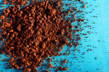 Close-up of instant coffee heap on blue background