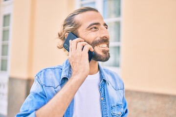 Young middle eastern man talking on the smartphone at the city.