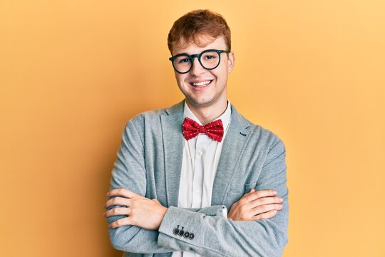 Young caucasian nerd man wearing glasses wearing hipster elegant look with bowtie happy face smiling with crossed arms looking at the camera. positive person.