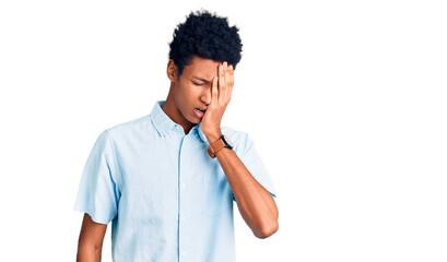 Young african american man wearing casual clothes yawning tired covering half face, eye and mouth with hand. face hurts in pain.