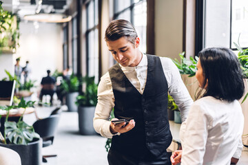 Handsome hipster business man relaxing using digital smartphone at table at office,playing game online and social media