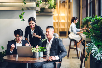 Group of professional multiethnic teamwork business discussing meeting strategy sharing idea with new startup project.Creative business people working with laptop computer in green plant terrace 