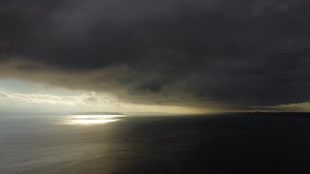 Dramatic dark clouds over the Puget Sound ocean water in Washington State