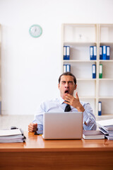 Young male employee working at workplace