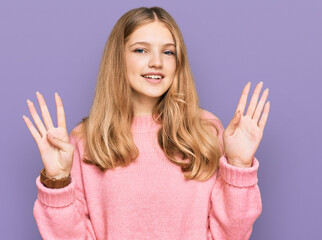 Beautiful young caucasian girl wearing casual winter sweater showing and pointing up with fingers...