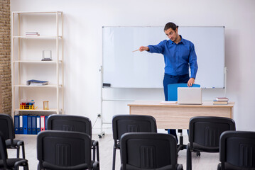 Fototapeta premium Young male business trainer making presentation during pandemic