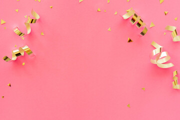 gold color of rolling ribbon and confetti on pink background with copy space for valentine and...