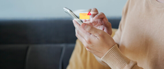 close up employee man hand holding smartphone to checking alert from mailbox with warning sign for...