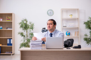 Naklejka premium Young male employee sitting in the office