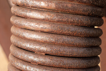 Brown, black and yellow rust and stains on a car shock-shaped coil Brown abstract texture and metal...