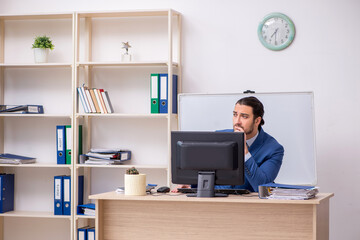 Young male businessman employee working in the office