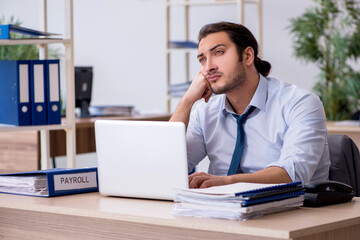 Young male bookkeeper working in the office