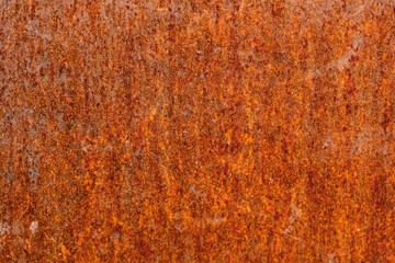 Rusty corrosive wall, iron covered with rust and corrosion paint. Rust metal background. Grunge steel texture. Oxidized iron sheet. Industry corroded backdrop