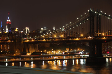 Fototapeta na wymiar Manhattan skyline seen at night from the Brooklyn Bridge across the East River