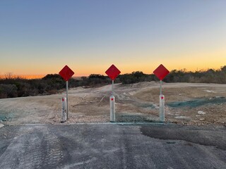 Construction road signs with sunset background