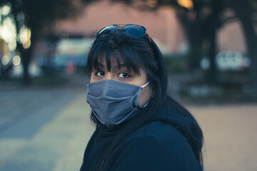 Portrait of woman wearing personal protective equipment on the street
