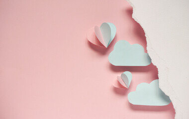 Blue and pink balloon made from paper folded floating in the air placed on pink background