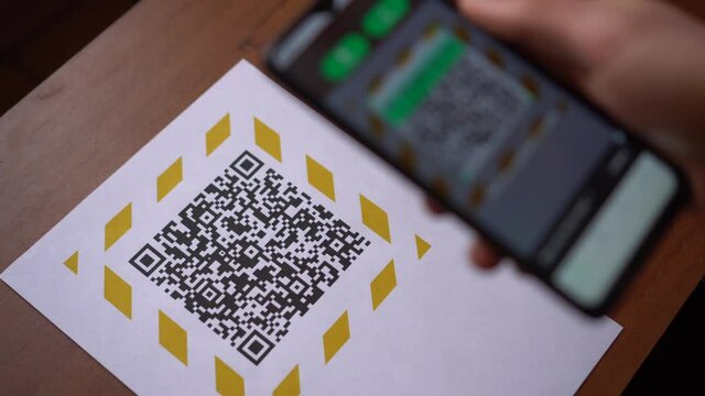 Scanning the QR code on the display using a smartphone. Internet URL, encrypted data, e-ticket, menu, contactless payment, citizen ID card, pass