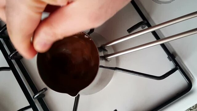 Making Turkish coffee in a cezve on the stove
